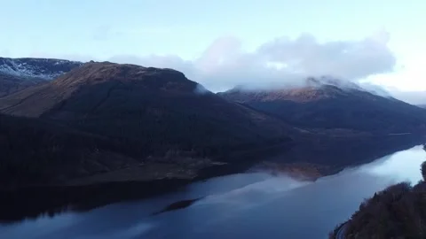 Slow Push In High Over Calm Waters of Scottish Loch With Mountains and Clouds Stock Footage 277731723