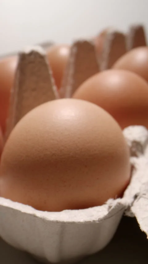Slow Push-In Over a Cardboard Egg Carton with Fresh Eggs Stock Footage 345589566