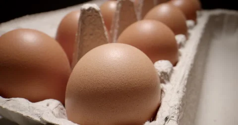 Slow Push-In Over a Cardboard Egg Carton with Fresh Eggs Stock Footage 345589890