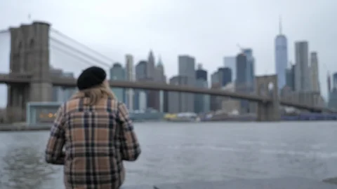 Slow push in over the shoulder of attractive young woman looking at Manhattan NY Stock Footage 121572433