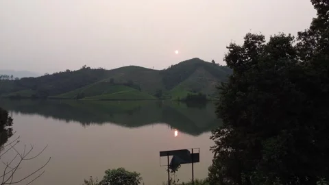 Slow Push Past Trees Towards Lake at Dusk Stock Footage 255037885