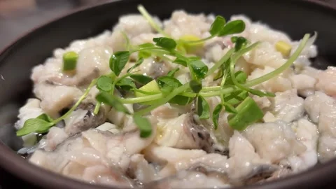 Slow Push-In Shot of Middle Eastern-Style Lemon Sea Bass Dish Stock Footage 332749460
