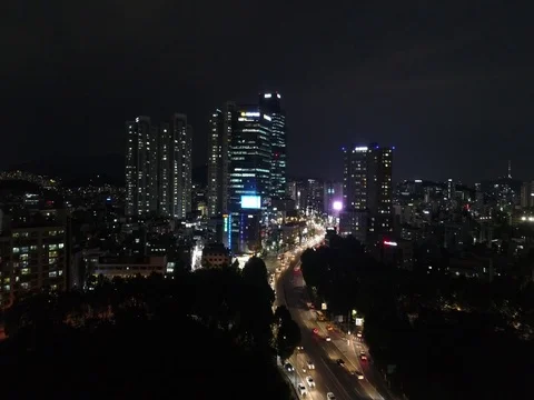 Slow push toward and climb over city buildings in Seoul Stock Footage 78122999