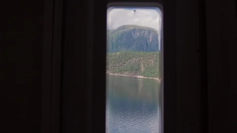 Slow push in toward a window of moving RV during road trip in Norway Stock Footage 103612243
