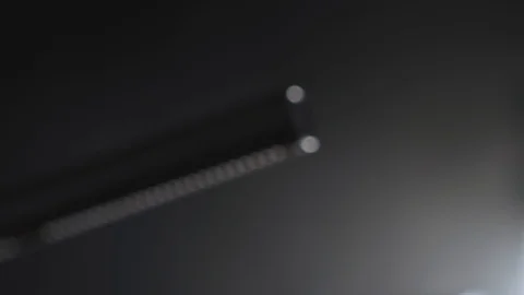 Slow rack focus to a condenser microphone in a dark studio or room Video stock 124041417