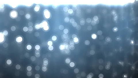 A slow, relaxing background of light particles moving in pale blue space. Stock Footage 241058060