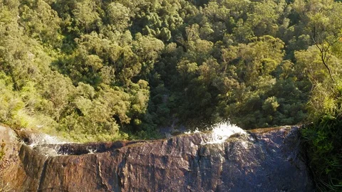 Slow reveal over the edge of a long drop water fall in the Blue Mountains Stock Footage