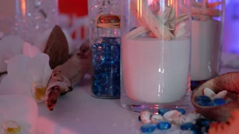 Slow revealing shot of beach shells and sand decorations on a wedding table Stock Footage 289740595