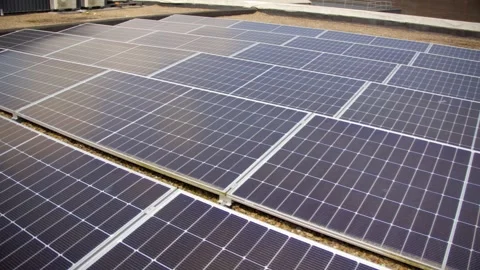 Slow revealing video of a solar panel array filmed on a bright and sunny day Stock Footage 314783233