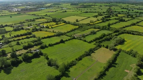 A slow reverse aerial flight over the patchwork of fields in Wiltshire UK Video stock 196897898