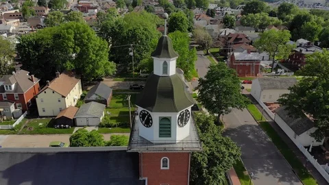 Slow Reverse Aerial View of Small Town's Church Steeple  	 Stock Footage 90025887