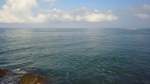 Slow reverse flight over ocean and tide pools at Playa Avellana Costa Rica Stock Footage 90919395
