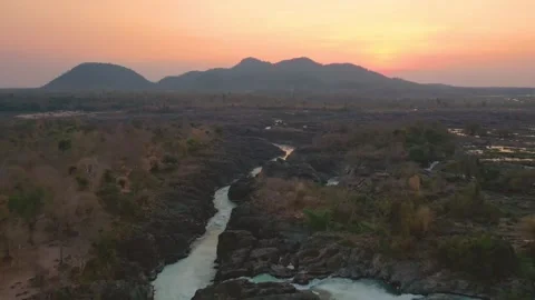 Slow reverse travelling of Li Phi Somphamit Waterfalls at sunset. Don Det, Laos. Stock Footage 246940304