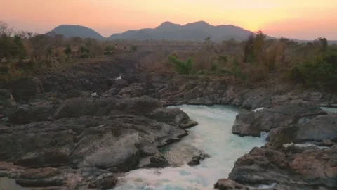 Slow reverse travelling of Li Phi Somphamit Waterfalls at sunset. Don Det, Laos. Stock Footage 246940549