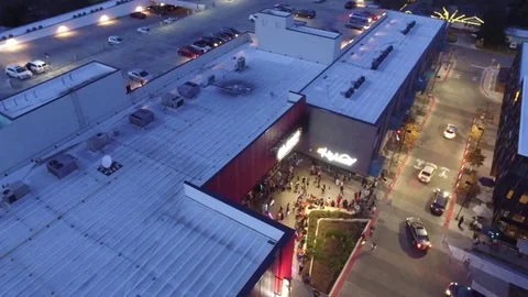 Slow Right Pan Aerial Drone Establishing Shot of Contemporary Movie Theater Stock Footage 71104777