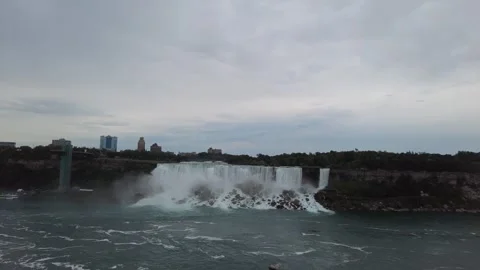Slow right pan along the American Falls curtain and its boulder talus Stock Footage 345996039