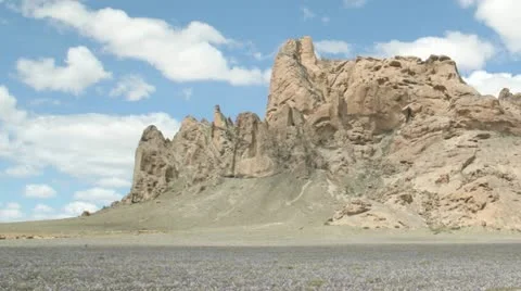 Slow right pan of a time-lapse shot of New Mexico's Shiprock. Stock Footage