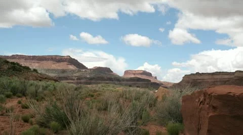 Slow right-pan of a time-lapse shot showing clouds passing over Utah's Mexican Video stock 11520575