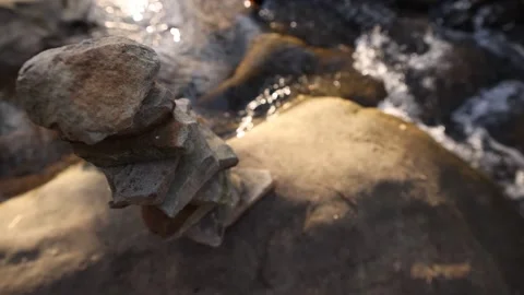 Slow Rise Up Wide Angle View Over Stacked Rocks Near River Vídeo Stock 315225343