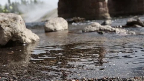Slow river flowing under bridge and rocks_Rack focus Stock Footage 71310019