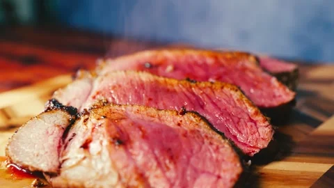 Slow-Roasted Topside Beef Sliced on Board Stock Footage 325337678