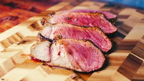 Slow-Roasted Topside Beef Sliced on Board Stock Footage 325337682
