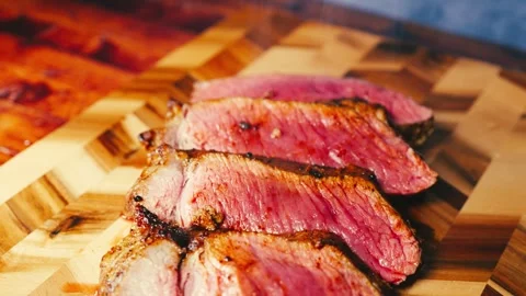Slow-Roasted Topside Beef Sliced on Board Stock Footage 325337683