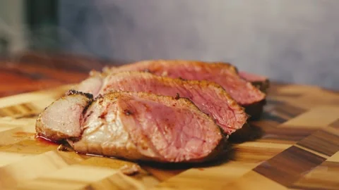 Slow-Roasted Topside Beef Sliced on Board Stock Footage 325337700