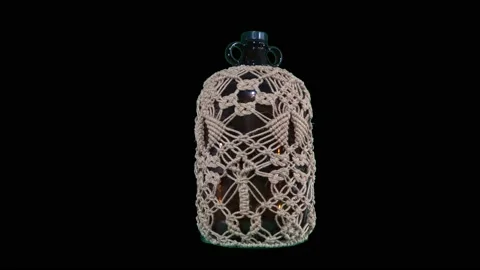SLOW Rotating bottle with rope decoration and transparent background Video stock 236354521