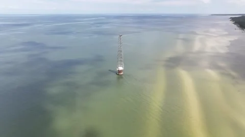 Slow rotating flight around navigation beacon Nassawadox Point 스톡 동영상 280447596