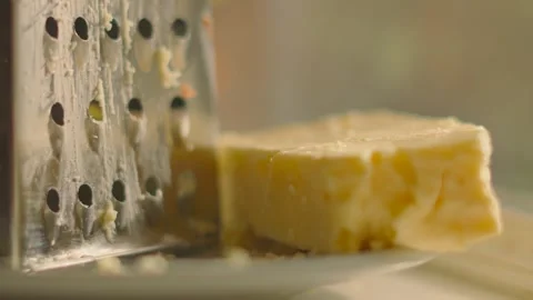 Slow Rotating Focus Pull Across Freshly Grated British Mature Cheddar Cheese Video stock 313926710