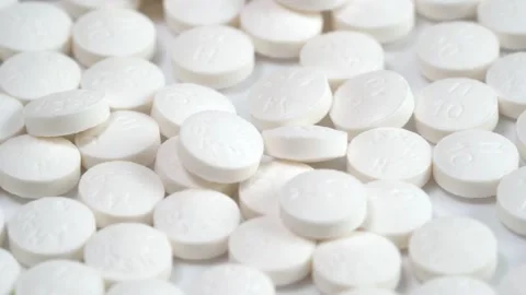 Slow rotation of a large group of white pills on a white background Stock Footage 140291512