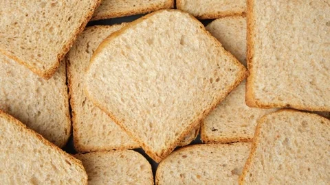 Slow rotation of toasted whole wheat brown bread pieces. Stock Footage 337928834