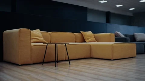 Slow shot of a wide, brown sofa, with two large pillows of the same color, next Stock Footage 231508056