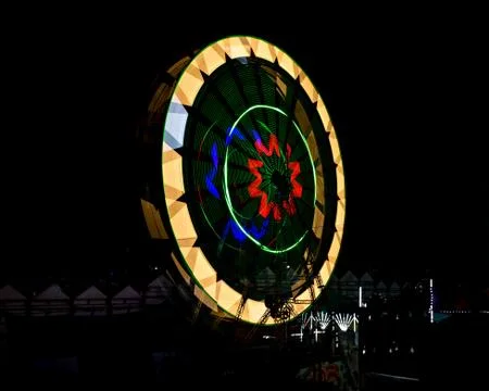 Slow shutter, night image of a spinning giant wheel in funfair in Pune, India Stock Photos