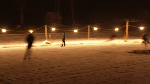 Slow shutter shot of night pond hockey skaters Stock Footage 147403869