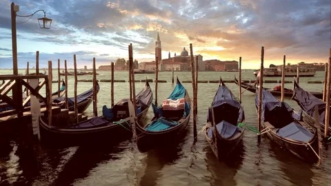 Slow shutter shot at sunset of Gondolas at Saint Mark's Square looking toward Stock Footage 83303559