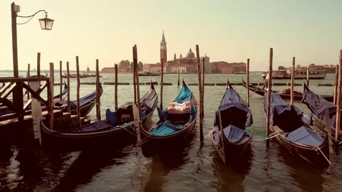 Slow shutter shot at sunset of Gondolas at Saint Mark's Square looking toward Stock Footage 83304561