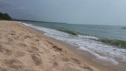 A slow-shutter shot of waves gently lapping against the golden beach. Stock Footage 344093953