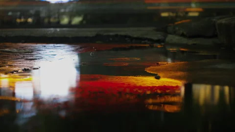 Slow shutter traffic reflections in a rain puddle in Bangkok Stock Footage 345981393