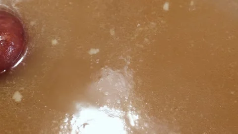 Slow simmer of bone broth in a home kitchen: rich, comforting stock Stock Footage 344031950