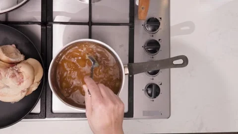 Slow-simmered bone broth in a home kitchen pot highlighting long, rich simmer Stock Footage 344031914