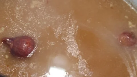 Slow-simmered bone broth in a pot: long-cooking, rich homemade stock Stock Footage 344031919