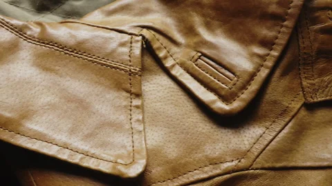 Slow Slide Close Up of Detailed Stitching on Premium Brown Leather Jacket Lapels Stock Footage 340856905