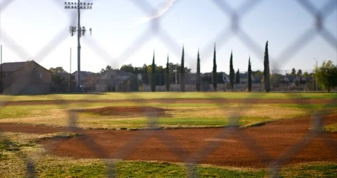 Slow slide right looking out at an empty green baseball field diamond from Stock Footage 97495781
