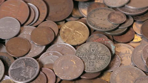 Slow slider across collection of foreign coins Stock Footage 141679520