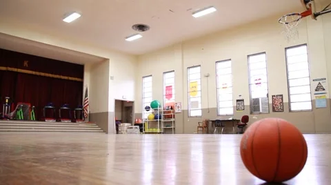 Slow Slider across floor of empty elementary school Gym Video stock 58163458