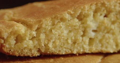 Slow sliding on baked cornbread cross section 4K video Stock Footage 251237512