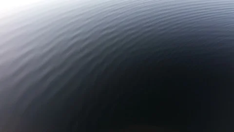 Slow small ripples waves, waveform on still lake - Abstract Stock Footage 106733799