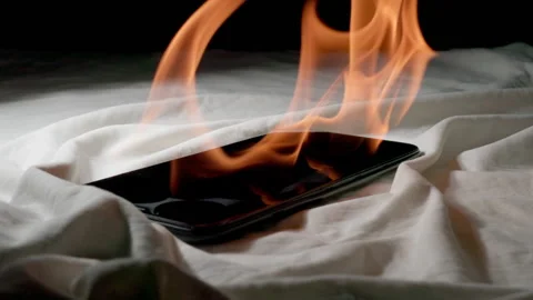 SLOW: Smartphone is burning on a bed at home Stock Footage 202065802
